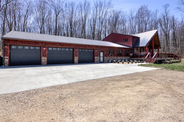 546 315th St, Cady Twp, WI 54749 - view of front of house with concrete driveway, a metal roof, and an attached garage