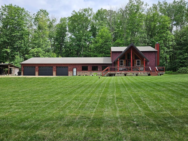 546 315th St, Cady Twp, WI 54749 - log cabin featuring a front lawn, a garage, a metal roof, and a deck