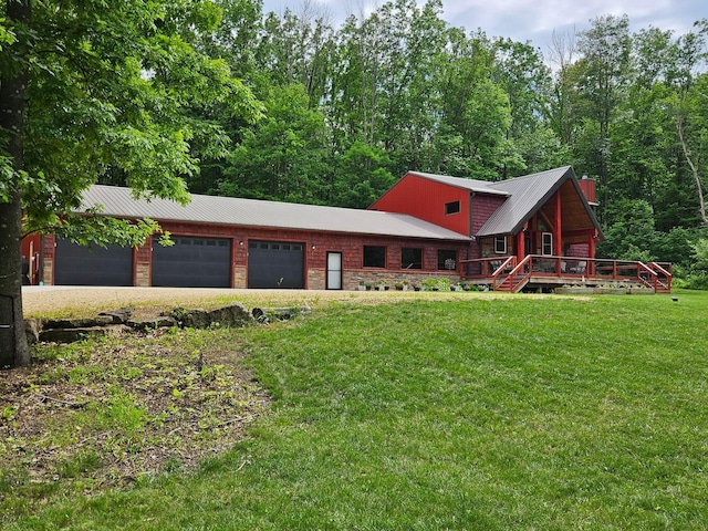 546 315th St, Cady Twp, WI 54749 - view of front of home featuring a metal roof, a front lawn, a garage, and driveway