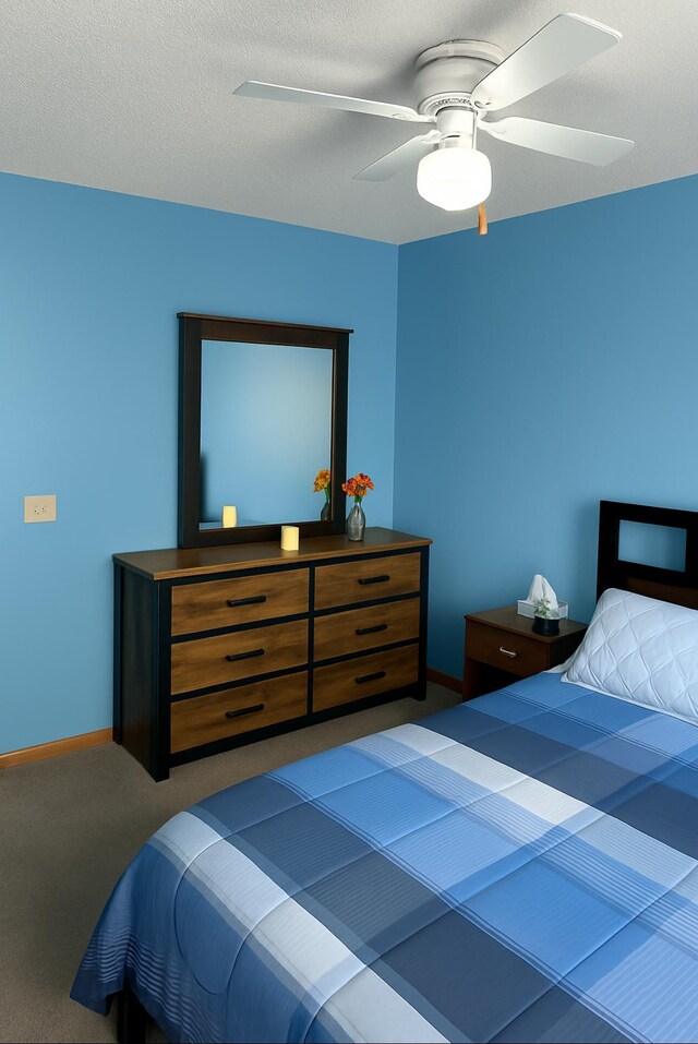 bedroom with baseboards, ceiling fan, and carpet flooring