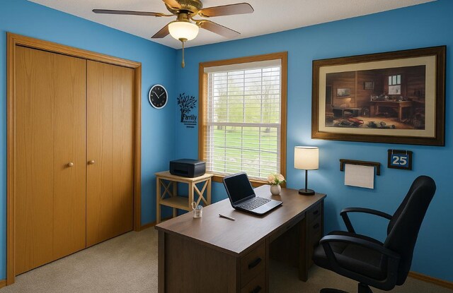 office with baseboards, ceiling fan, and light colored carpet