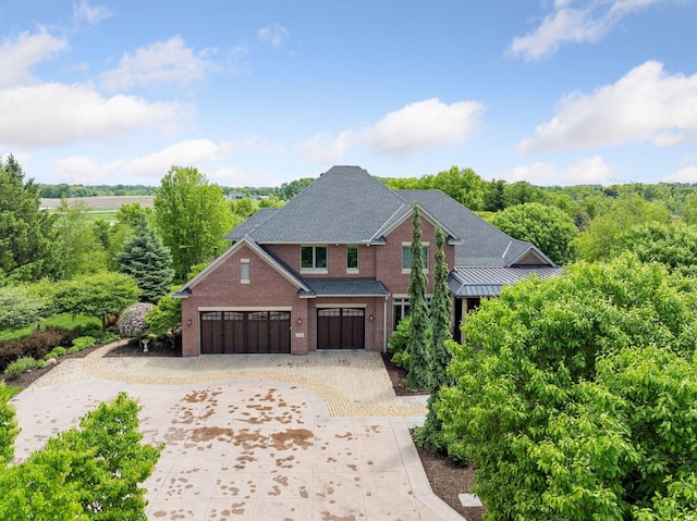7250 Jubert Ln, Corcoran, MN 55340 - traditional-style home featuring brick siding, curved driveway, and a garage