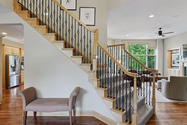 7250 Jubert Ln, Corcoran, MN 55340 - stairway featuring wood finished floors, a ceiling fan, recessed lighting, and baseboards