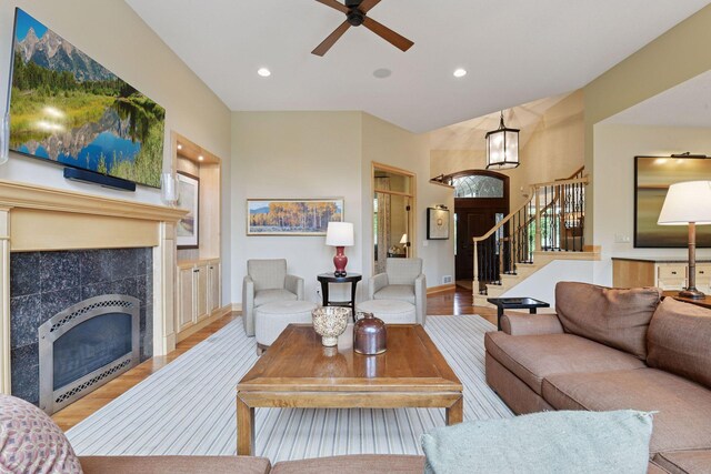 7250 Jubert Ln, Corcoran, MN 55340 - living room with wood finished floors, stairway, a fireplace, recessed lighting, and a ceiling fan