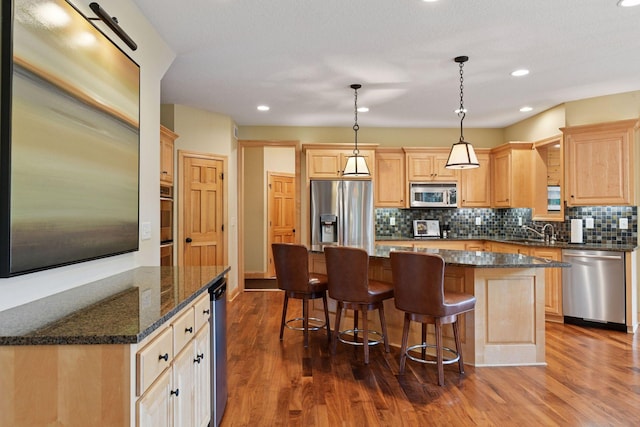 7250 Jubert Ln, Corcoran, MN 55340 - kitchen with stainless steel appliances, light brown cabinetry, a kitchen island, a sink, and recessed lighting