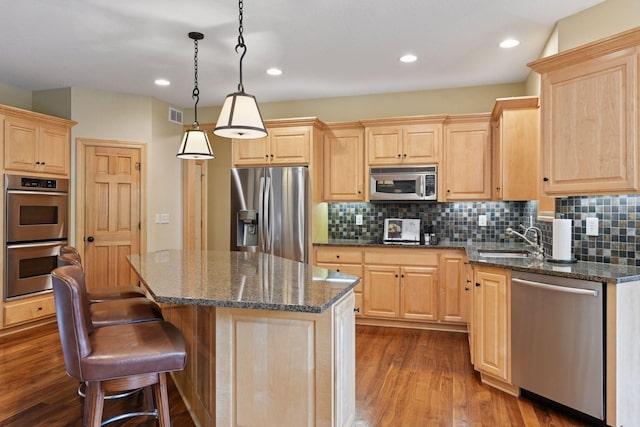 7250 Jubert Ln, Corcoran, MN 55340 - kitchen featuring stainless steel appliances, light brown cabinetry, a sink, dark wood-style floors, and a center island