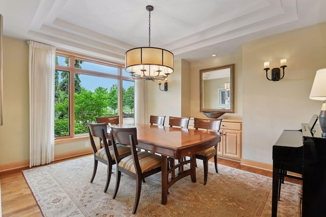 7250 Jubert Ln, Corcoran, MN 55340 - dining area featuring a raised ceiling, a chandelier, and plenty of natural light