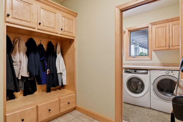 7250 Jubert Ln, Corcoran, MN 55340 - washroom with washing machine and clothes dryer, cabinet space, light tile patterned floors, and baseboards