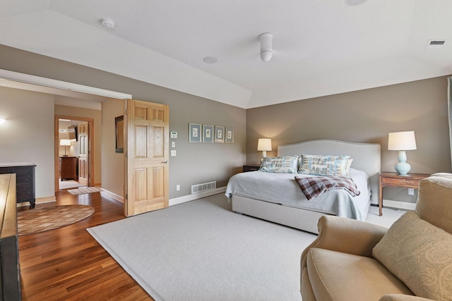 7250 Jubert Ln, Corcoran, MN 55340 - bedroom with dark wood-style flooring, baseboards, and vaulted ceiling