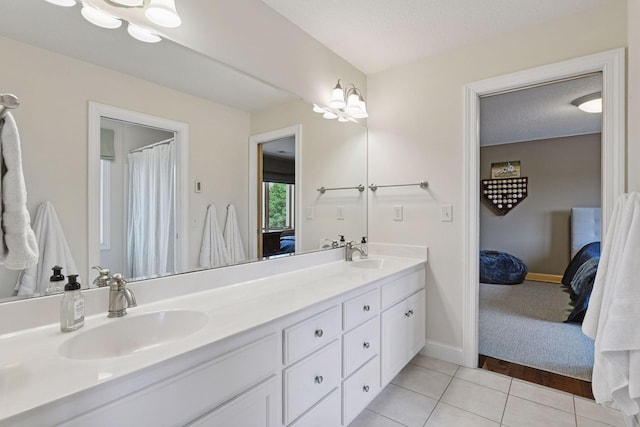 7250 Jubert Ln, Corcoran, MN 55340 - full bathroom with ensuite bathroom, double vanity, tile patterned flooring, and baseboards