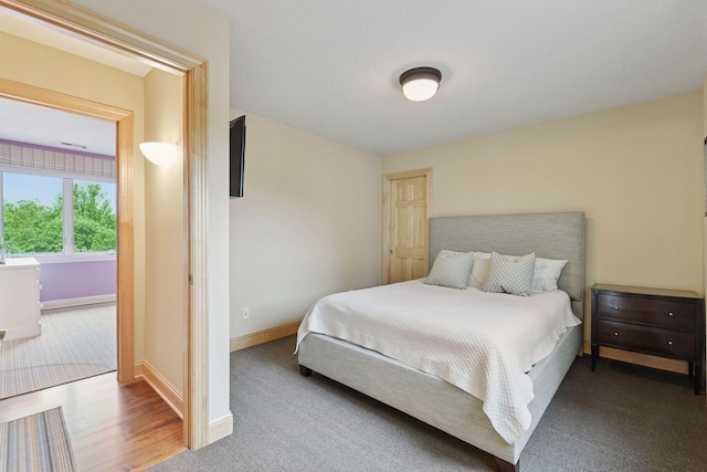 7250 Jubert Ln, Corcoran, MN 55340 - carpeted bedroom with baseboards and wood finished floors