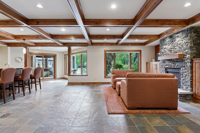 7250 Jubert Ln, Corcoran, MN 55340 - living area featuring stone tile floors, baseboards, beamed ceiling, recessed lighting, and a stone fireplace