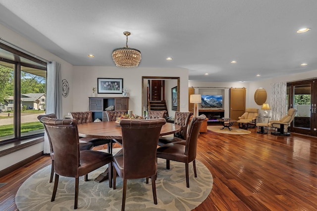 dining room featuring wood finished floors, a chandelier, recessed lighting, and baseboards