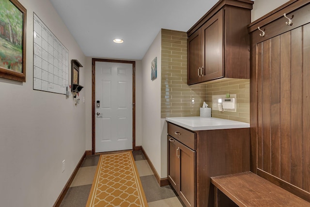 laundry area with baseboards and recessed lighting