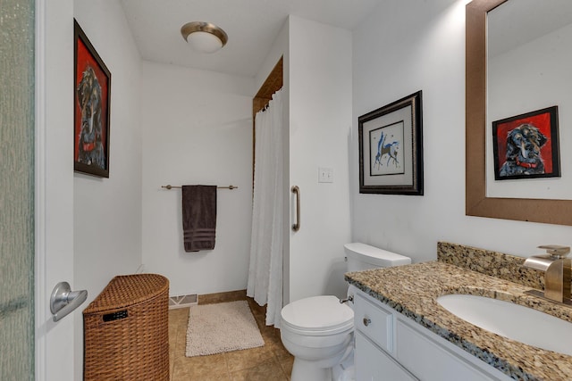 bathroom featuring toilet, vanity, tile patterned floors, and a shower with curtain