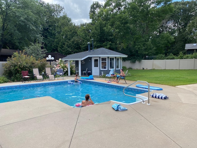 view of swimming pool with a patio, a storage structure, and an outdoor structure
