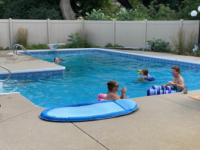 view of pool with a fenced backyard