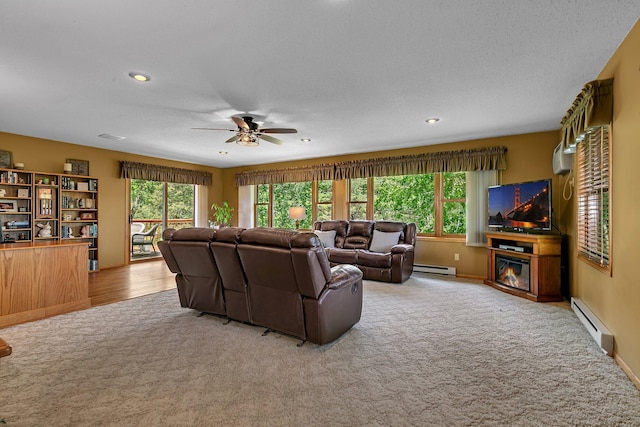 1410 4th Ave N, Sartell, MN 56377 - carpeted living area with a baseboard radiator, healthy amount of natural light, ceiling fan, a textured ceiling, and recessed lighting