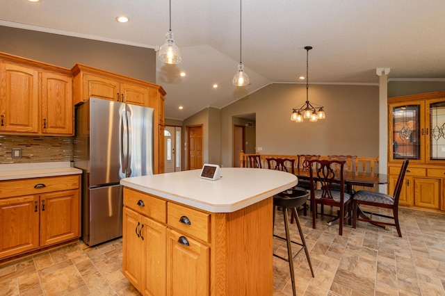 235 Morning View Rd, Sauk Centre, MN 56378 - kitchen featuring freestanding refrigerator, a breakfast bar area, a kitchen island, and stone finish floor