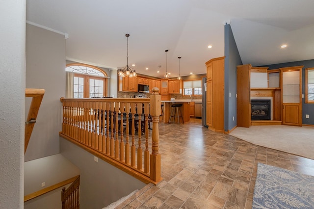 235 Morning View Rd, Sauk Centre, MN 56378 - interior space featuring a glass covered fireplace, a chandelier, recessed lighting, baseboards, and stone finish flooring