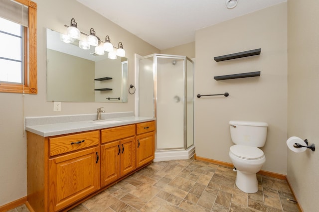 235 Morning View Rd, Sauk Centre, MN 56378 - bathroom with stone finish flooring, a stall shower, vanity, baseboards, and toilet