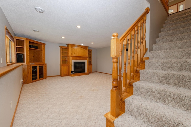 235 Morning View Rd, Sauk Centre, MN 56378 - interior space featuring a glass covered fireplace, baseboards, recessed lighting, and carpet floors