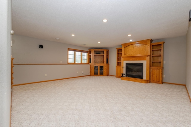 235 Morning View Rd, Sauk Centre, MN 56378 - unfurnished living room featuring recessed lighting, baseboards, a glass covered fireplace, and light colored carpet
