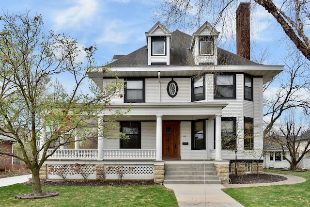 265 Broadway St, Winona, MN 55987 - traditional style home featuring covered porch, a chimney, a front yard, and roof with shingles