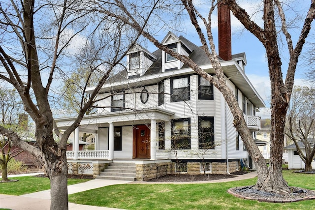 265 Broadway St, Winona, MN 55987 - american foursquare style home featuring a porch, a chimney, and a front yard