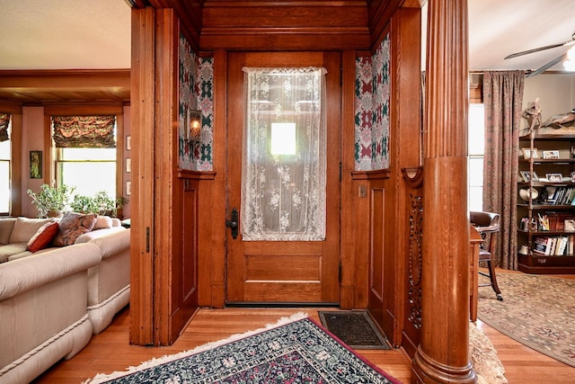 265 Broadway St, Winona, MN 55987 - entryway featuring wood finished floors, wood walls, and ceiling fan