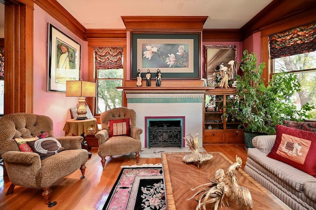 265 Broadway St, Winona, MN 55987 - sitting room featuring crown molding, wood finished floors, healthy amount of natural light, and a fireplace