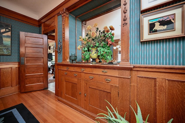 265 Broadway St, Winona, MN 55987 - detailed view of wallpapered walls, wood finished floors, a wainscoted wall, and ornamental molding