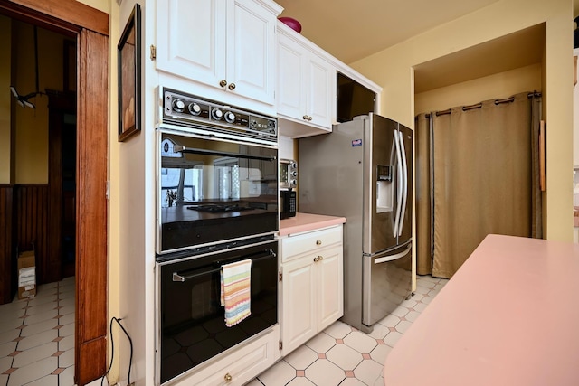 265 Broadway St, Winona, MN 55987 - kitchen featuring stainless steel fridge, light countertops, light flooring, and white cabinetry