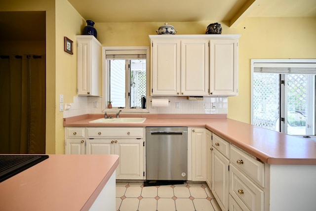 265 Broadway St, Winona, MN 55987 - kitchen with stainless steel dishwasher, decorative backsplash, light countertops, and a peninsula