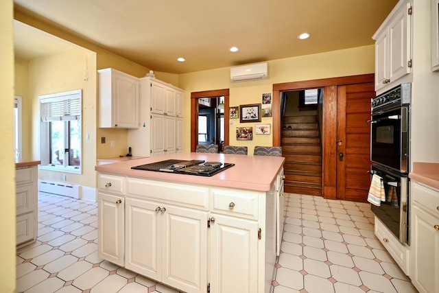 265 Broadway St, Winona, MN 55987 - kitchen with black appliances, a wall unit AC, light countertops, recessed lighting, and white cabinetry