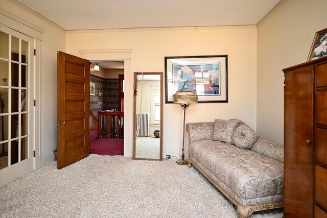 265 Broadway St, Winona, MN 55987 - sitting room featuring carpet flooring, crown molding, radiator, and an upstairs landing