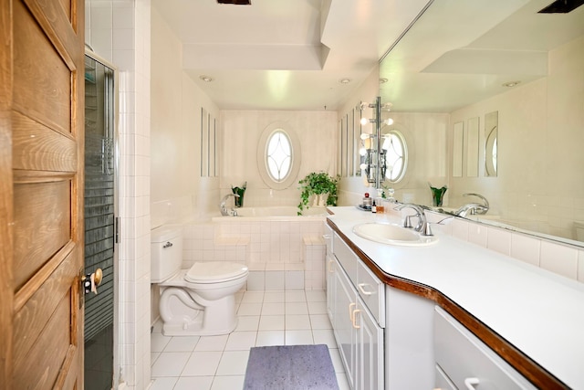 265 Broadway St, Winona, MN 55987 - bathroom featuring tile patterned flooring, vanity, a bath, and tile walls