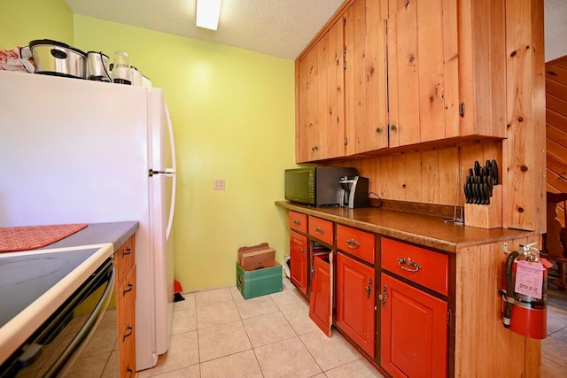 265 Broadway St, Winona, MN 55987 - kitchen featuring black microwave, a textured ceiling, dark countertops, light tile patterned floors, and electric range