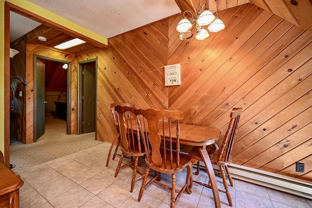 265 Broadway St, Winona, MN 55987 - dining room featuring wooden walls, a chandelier, light tile patterned flooring, baseboard heating, and light carpet