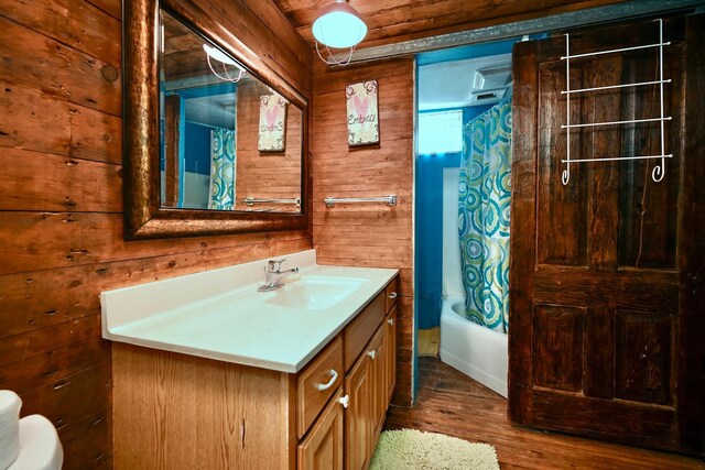 265 Broadway St, Winona, MN 55987 - full bathroom with wooden walls, vanity, wood finished floors, and shower / bath combination with curtain