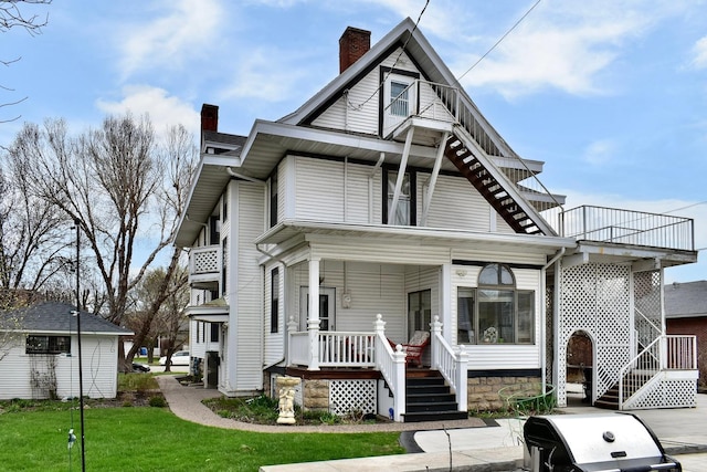 265 Broadway St, Winona, MN 55987 - view of front of property featuring a chimney, covered porch, stairs, and a front yard