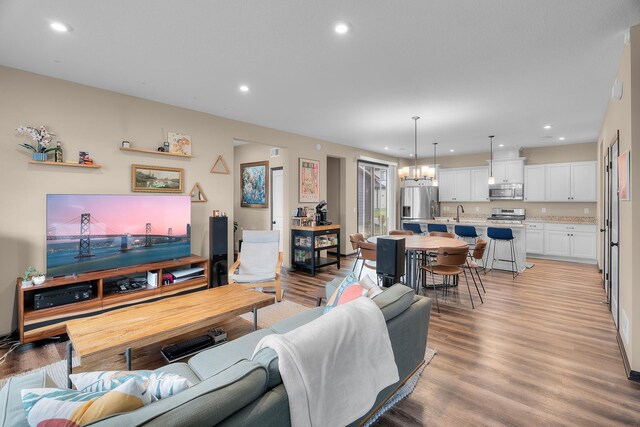 living area with recessed lighting and light wood finished floors