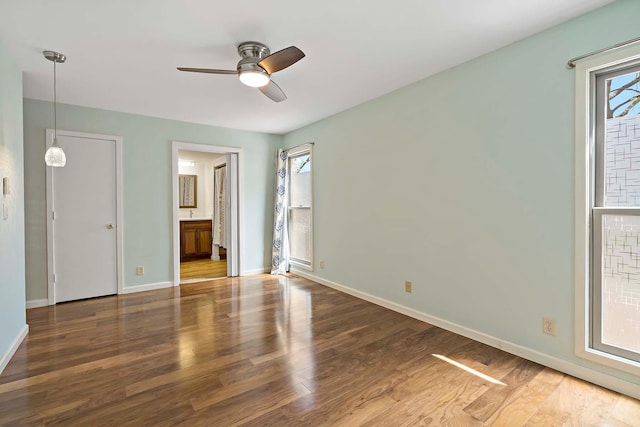 unfurnished bedroom featuring wood finished floors and baseboards