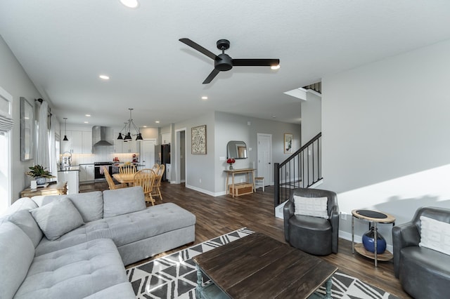 living area featuring recessed lighting, ceiling fan, dark wood-style flooring, and stairway