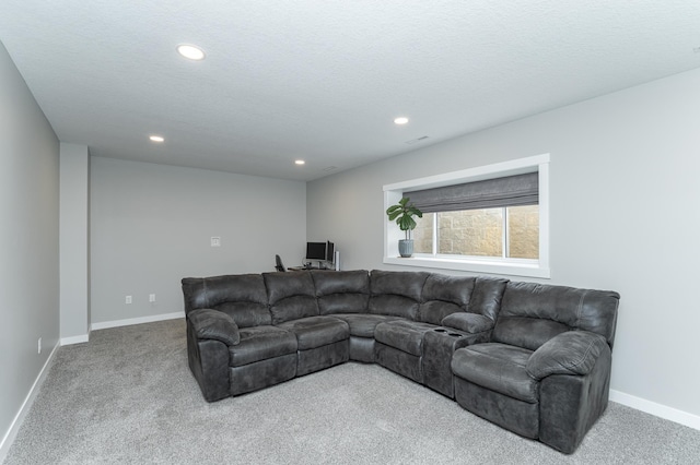 carpeted living room featuring baseboards, recessed lighting, and a textured ceiling