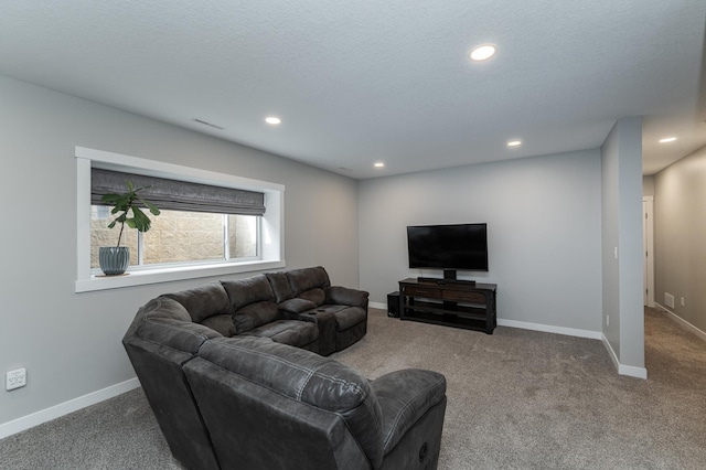 carpeted living area with recessed lighting and baseboards