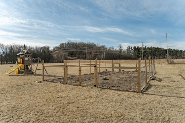 view of yard featuring fence and playground community