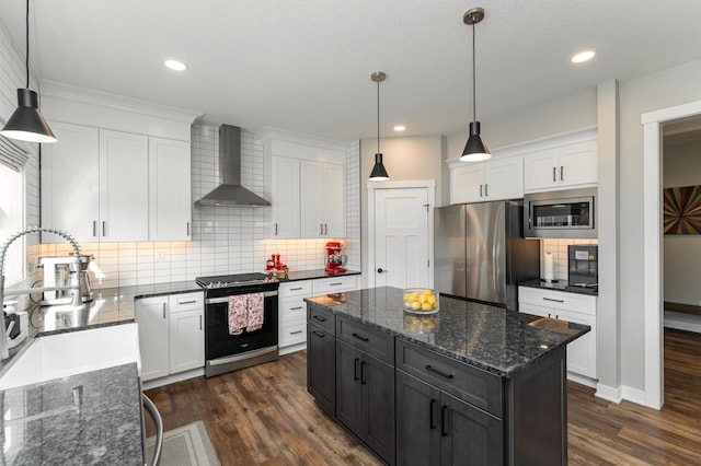 1261 Skyview Cir NW, Rochester, MN 55901 - kitchen featuring stainless steel appliances, wall chimney range hood, tasteful backsplash, a kitchen island, and white cabinetry