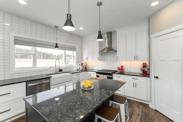 1261 Skyview Cir NW, Rochester, MN 55901 - kitchen with wall chimney range hood, a sink, appliances with stainless steel finishes, backsplash, and white cabinetry