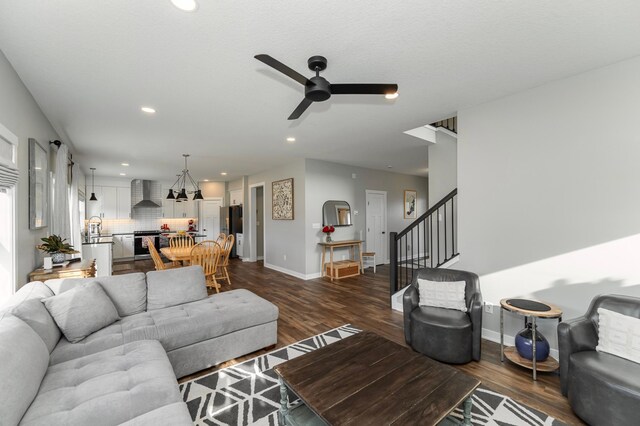 1261 Skyview Cir NW, Rochester, MN 55901 - living room with a ceiling fan, stairway, recessed lighting, dark wood finished floors, and baseboards